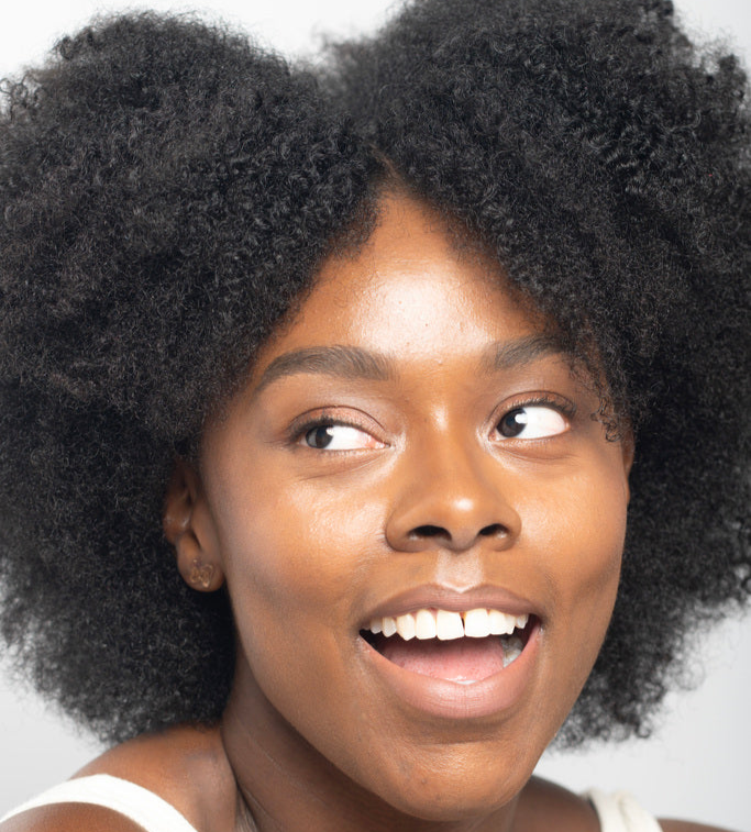 Woman with textured afro hair smiling